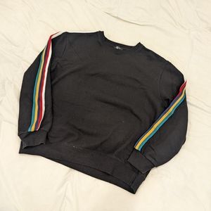 Black crewneck sweatshirt with rainbow striped sleeves